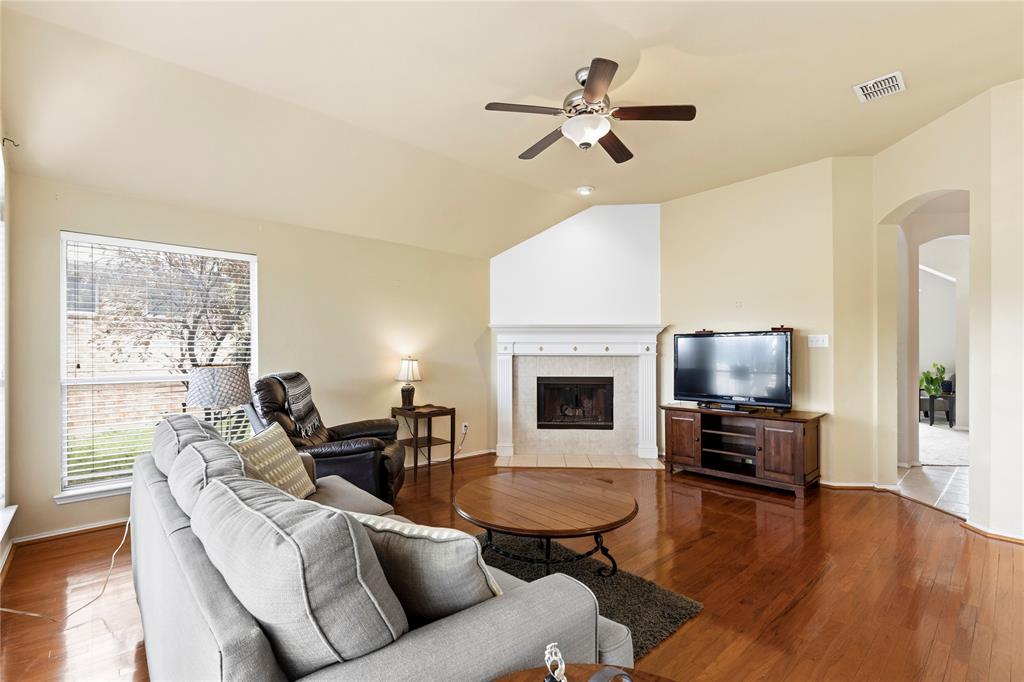 3724 Ranchman Boulevard Denton, TX 76210 - Photo 3 of 31 Living room with cozy wood-burning fireplace.