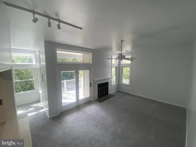 a view of a livingroom with an empty space and a fireplace