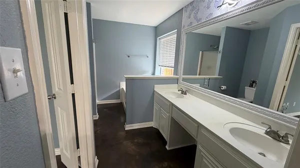a bathroom with a double vanity sink and mirror