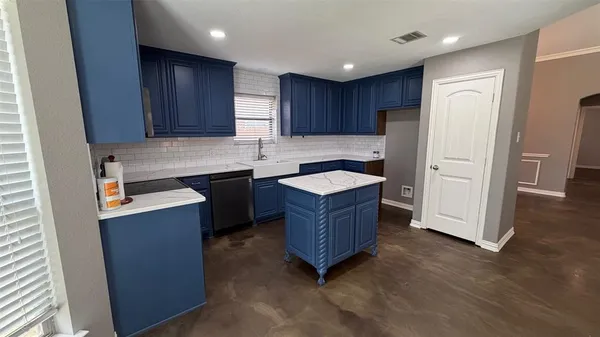 a kitchen with stainless steel appliances granite countertop a refrigerator a sink a stove a microwave and wooden cabinets