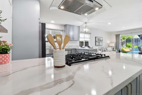 a kitchen with stainless steel appliances granite countertop a sink a stove and a refrigerator