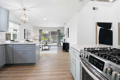 a kitchen with stove and cabinets