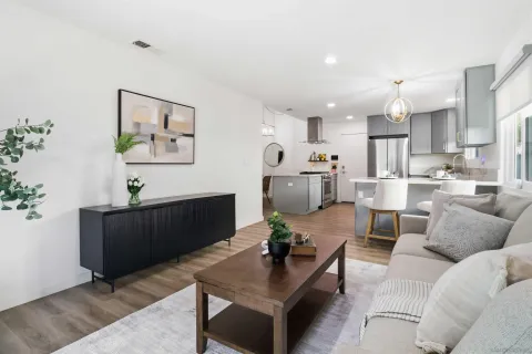 a living room with furniture and kitchen view
