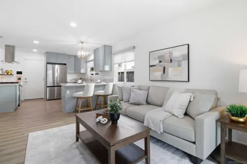 a living room with furniture and kitchen view