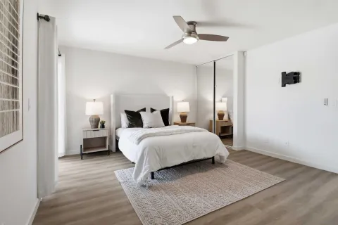 a bedroom with a bed and a chandelier
