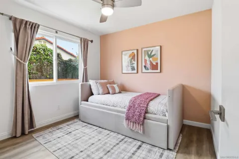 a bedroom with a bed and a painting on the wall