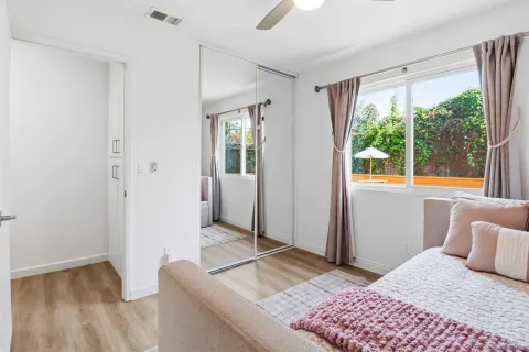 a bedroom with a bed and wooden floor