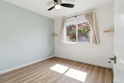 wooden floor in an empty room with a window