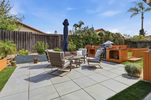 a view of a backyard with sitting area