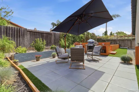 a view of backyard with outdoor seating and plants