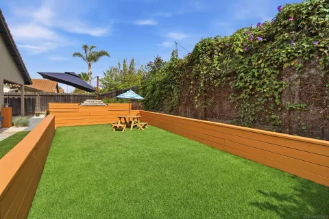 a view of a garden with lawn chairs