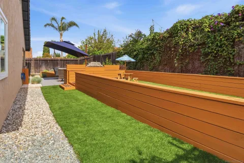 a backyard of a house with table and chairs