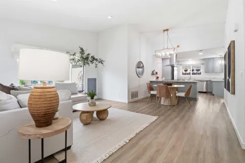 a living room with furniture and a chandelier
