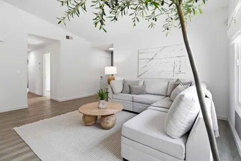 a living room with furniture and wooden floor