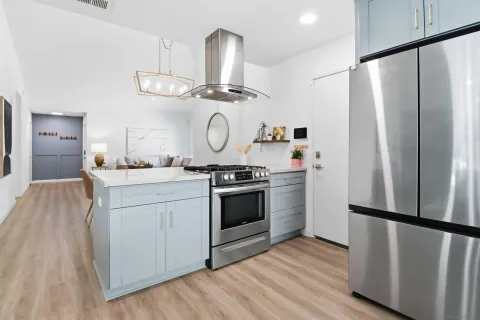 a kitchen with a refrigerator and a stove top oven