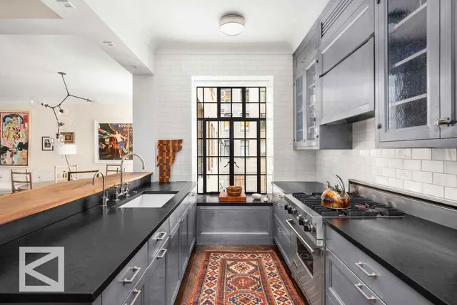 a kitchen with stainless steel appliances granite countertop a sink stove and cabinets