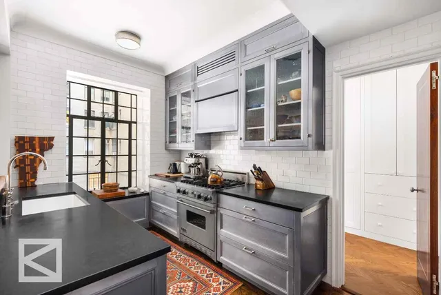 a kitchen with stainless steel appliances granite countertop a stove a sink and a refrigerator