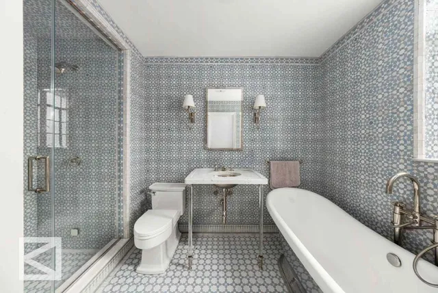 a bathroom with a toilet a sink and shower