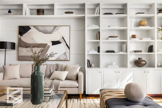 a living room with furniture cabinets and a rug