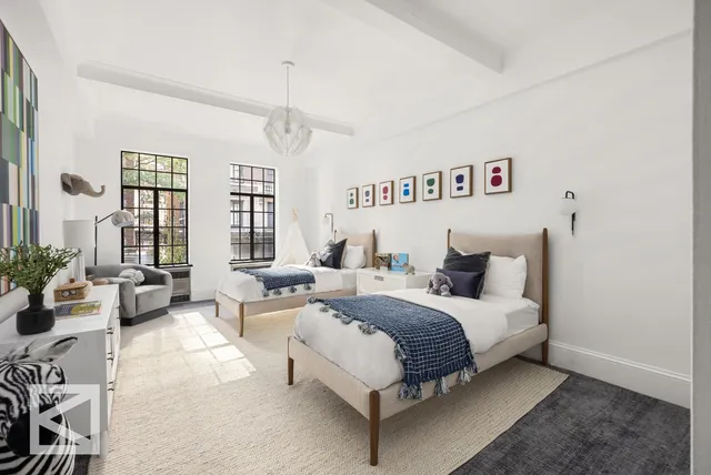 a spacious bedroom with a bed a couch and a window