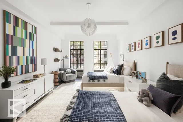 a bedroom with furniture and a large window