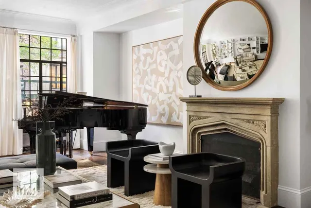 a living room with a fireplace and a floor to ceiling window