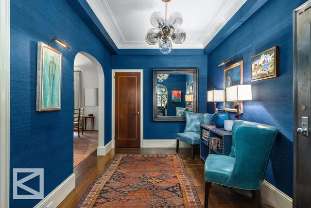 a living room with furniture and a chandelier