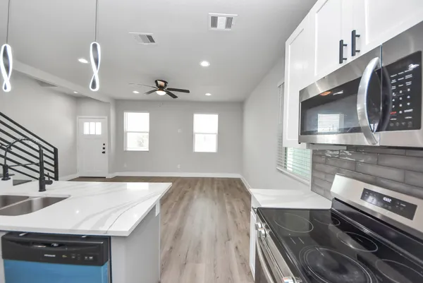 a bathroom with a granite countertop toilet a sink and a bathtub