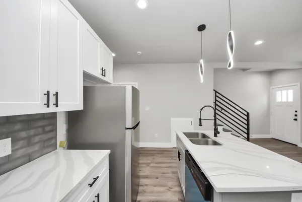 a bathroom with a granite countertop sink a mirror and vanity