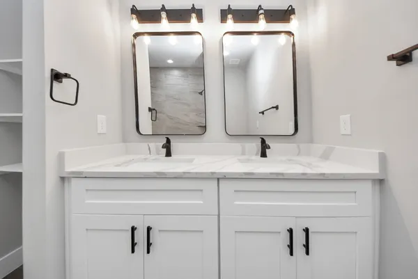 an empty room with wooden floor ceiling fan and windows