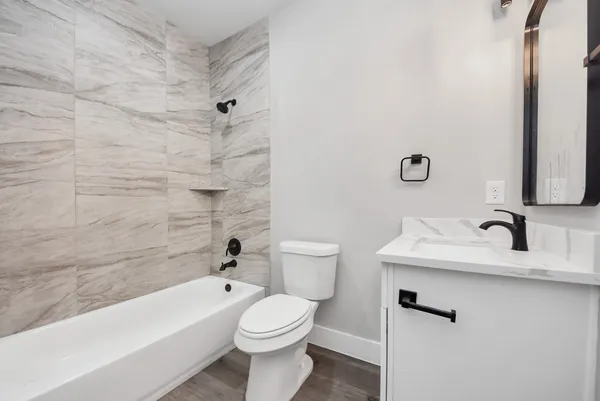 a bathroom with a white bath tub and a shower