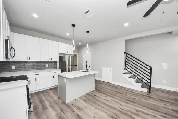 a kitchen with refrigerator and sink