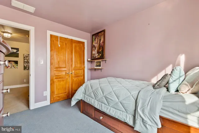 a bedroom with a bed and a cabinet