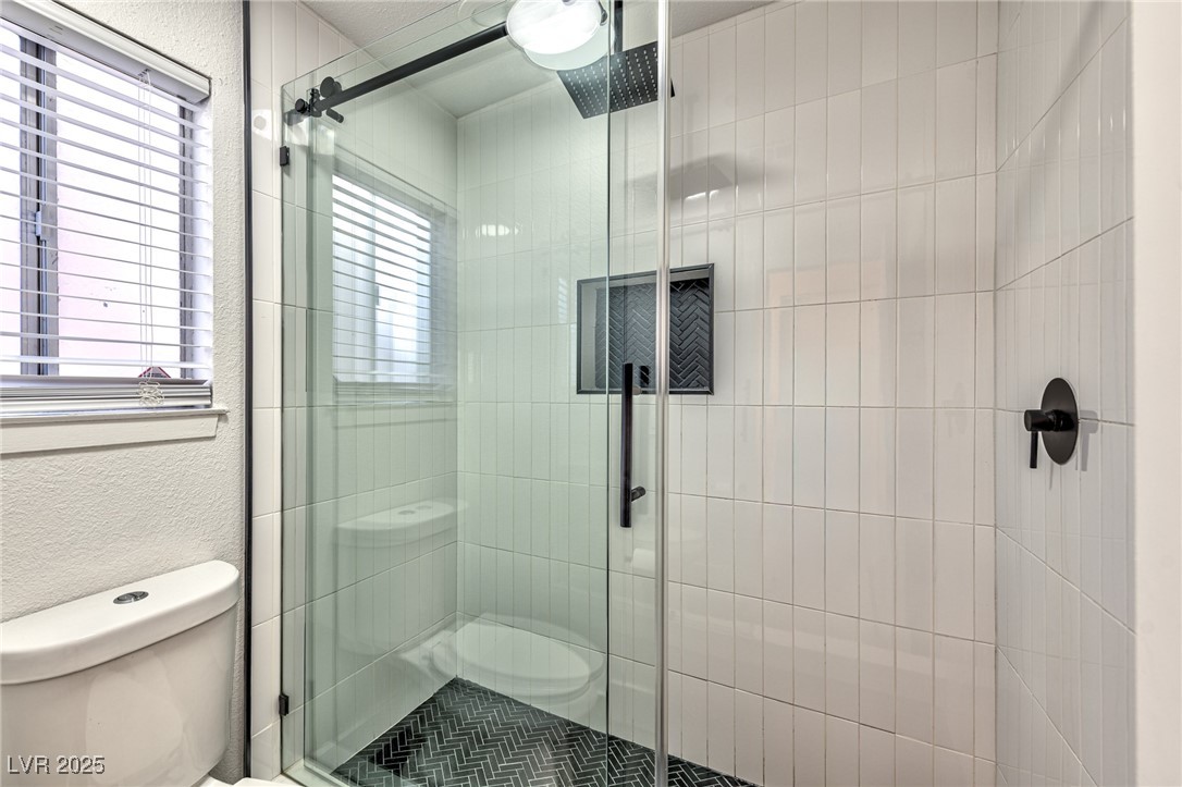 3017 Jamestown Way Las Vegas, NV 89102 - Photo 12 of 15 Full bathroom with a textured wall and a shower stall