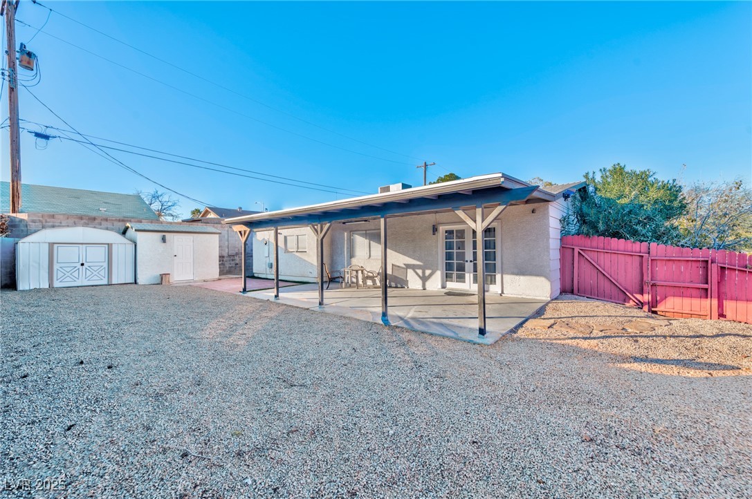 3017 Jamestown Way Las Vegas, NV 89102 - Photo 13 of 15 Back of property featuring a storage unit, a patio, a gate, stucco siding, and french doors