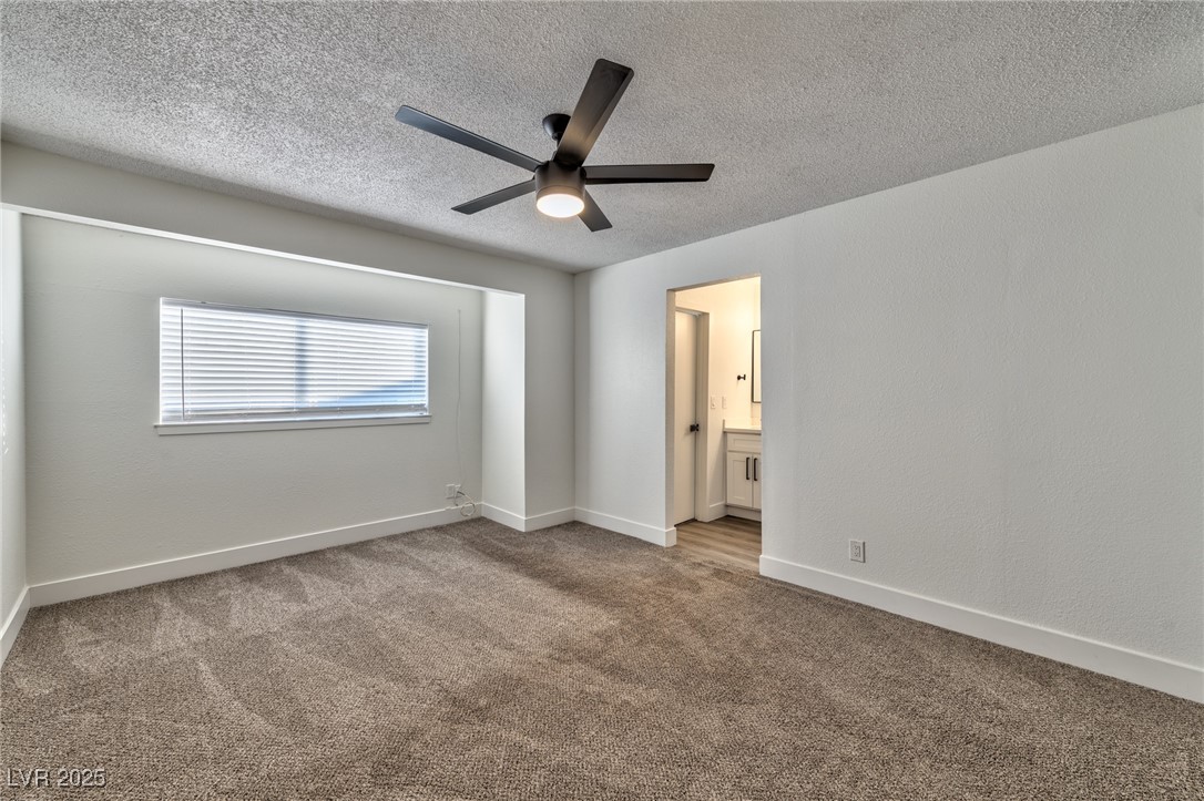 3017 Jamestown Way Las Vegas, NV 89102 - Photo 10 of 15 Unfurnished bedroom featuring carpet, connected bathroom, a ceiling fan, and a textured ceiling