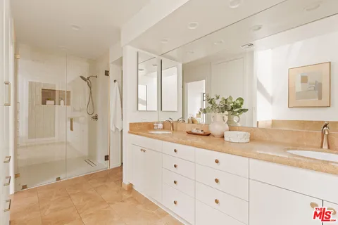 a bathroom with a granite countertop sink mirror and double