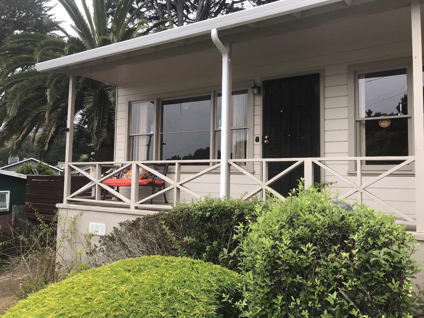 661 Brighton Road Pacifica, CA 94044 - Photo 2 of 18 a backyard of a house with table and chairs