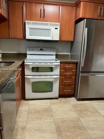 a kitchen with a stove top oven and cabinets