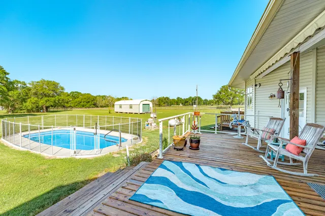 a view of a house with swimming pool and a yard