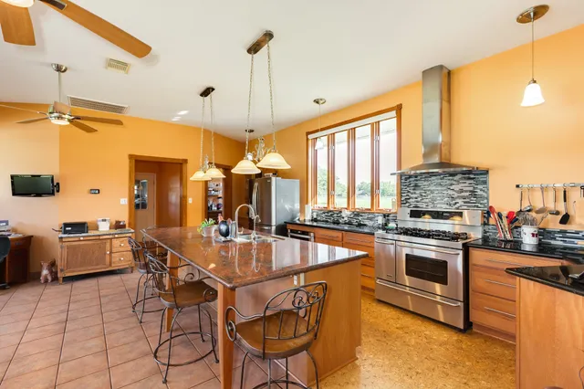 a very nice looking kitchen with a large window cabinets and stainless steel appliances