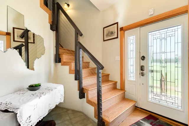 a living room with furniture a dining table and a fireplace