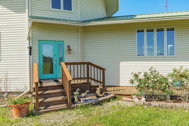 a backyard of a house with table and chairs