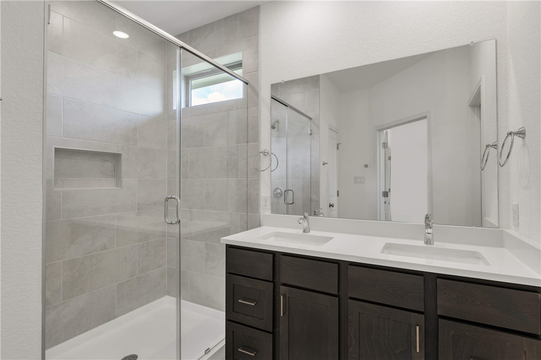 2776 Messenger Way Bryan, TX 77803 - Photo 14 of 16 a bathroom with a sink double vanity tub and shower