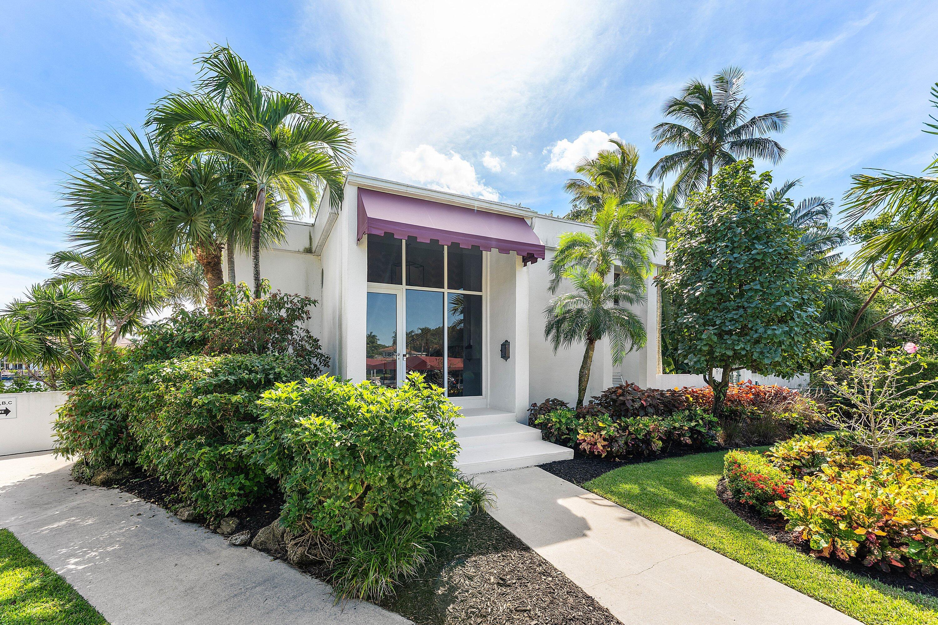 811 Palm Trail Delray Beach, FL 33483 - Photo 2 of 57 a plant is in front of the house