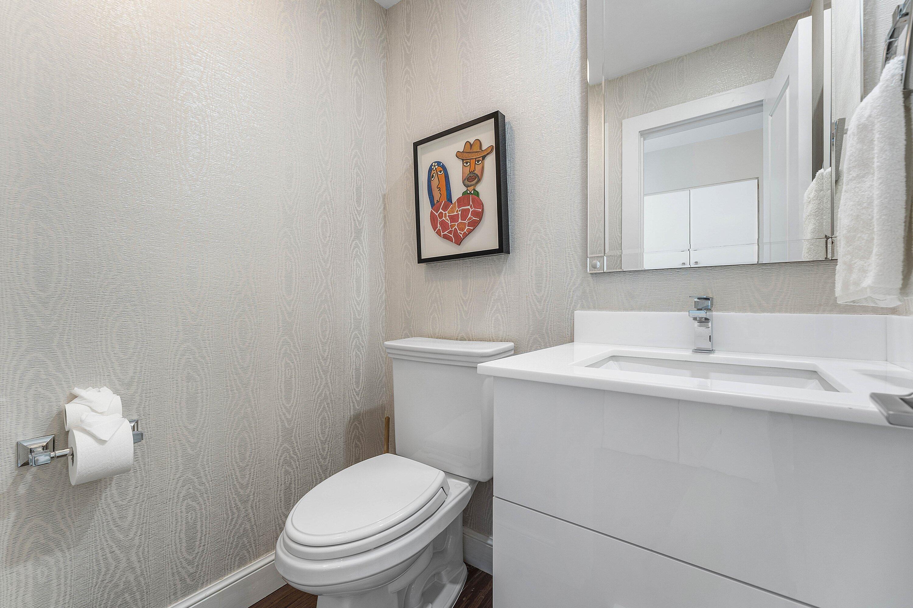 811 Palm Trail Delray Beach, FL 33483 - Photo 21 of 57 a bathroom with a toilet sink and mirror