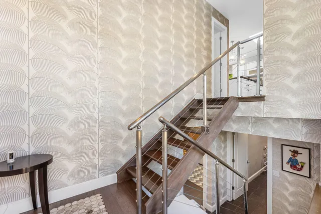 a living room with furniture and large windows