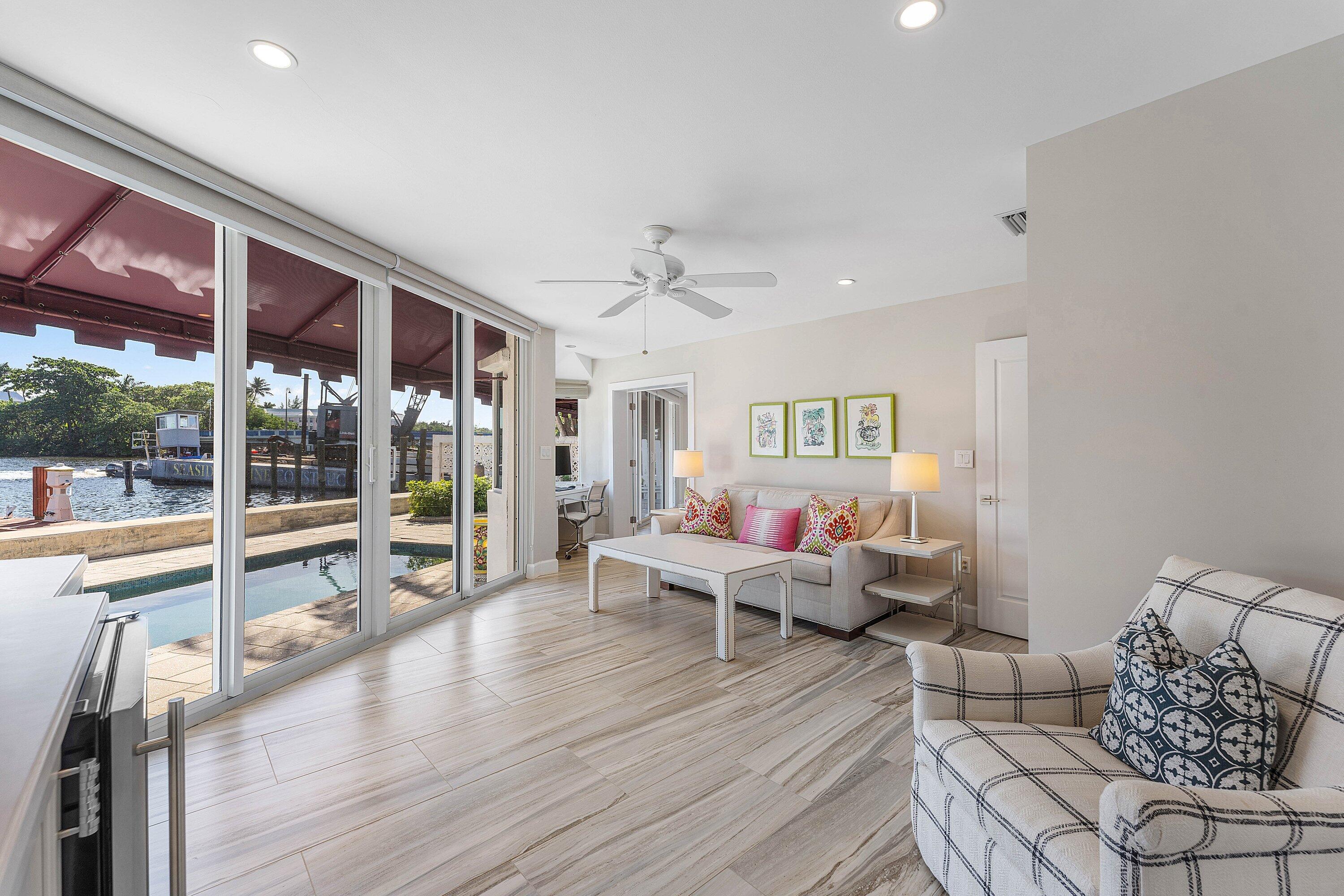 811 Palm Trail Delray Beach, FL 33483 - Photo 23 of 57 a living room with furniture and large windows