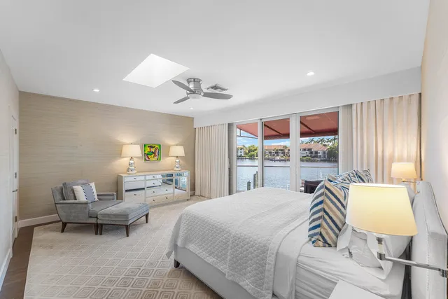 a spacious bedroom with a bed and a chandelier