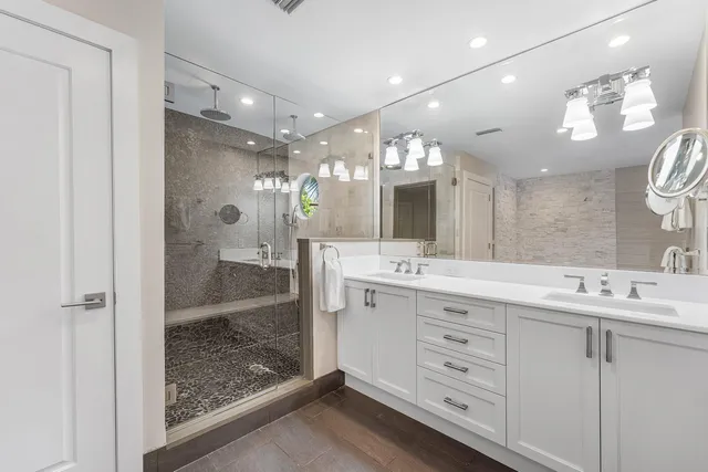 a bathroom with a shower vanity and a sink